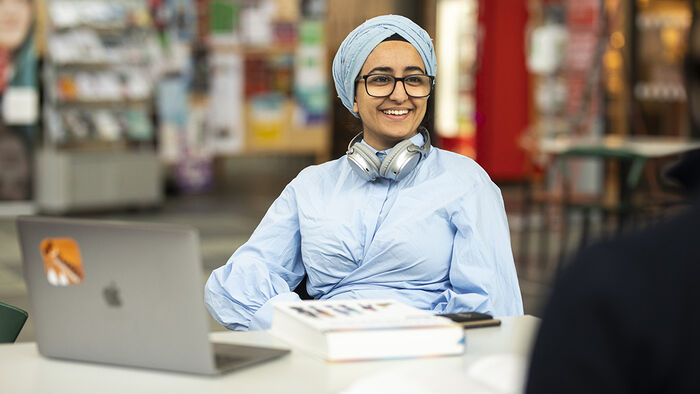 A female student sitting in the library. 