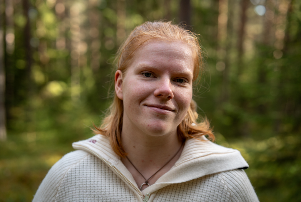Portrait of Karoline in the forest. She is smiling