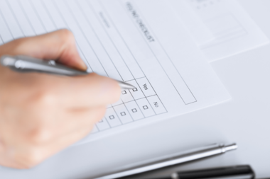 close up of hand with blank questionnaire 
