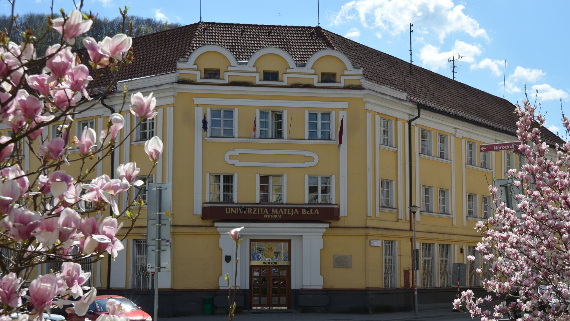 The yellow school building at UMB