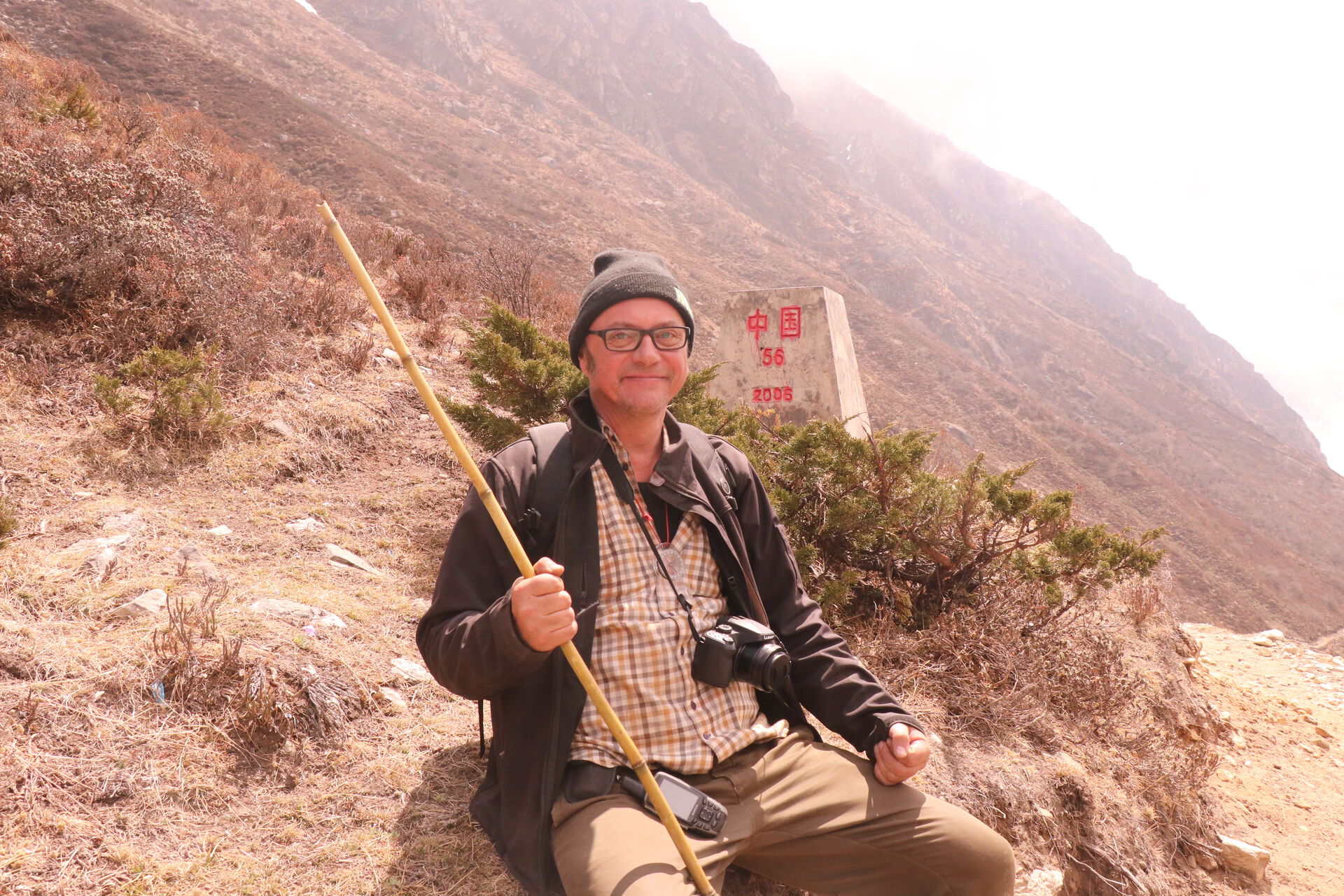 Morten Odden is sitting in hiking gear out in the nature in Nepal