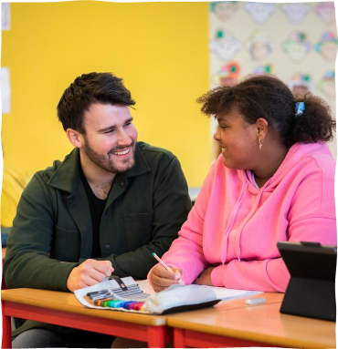 Two students are talking and smiling