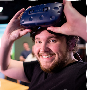 A happy man is holding VR glasses