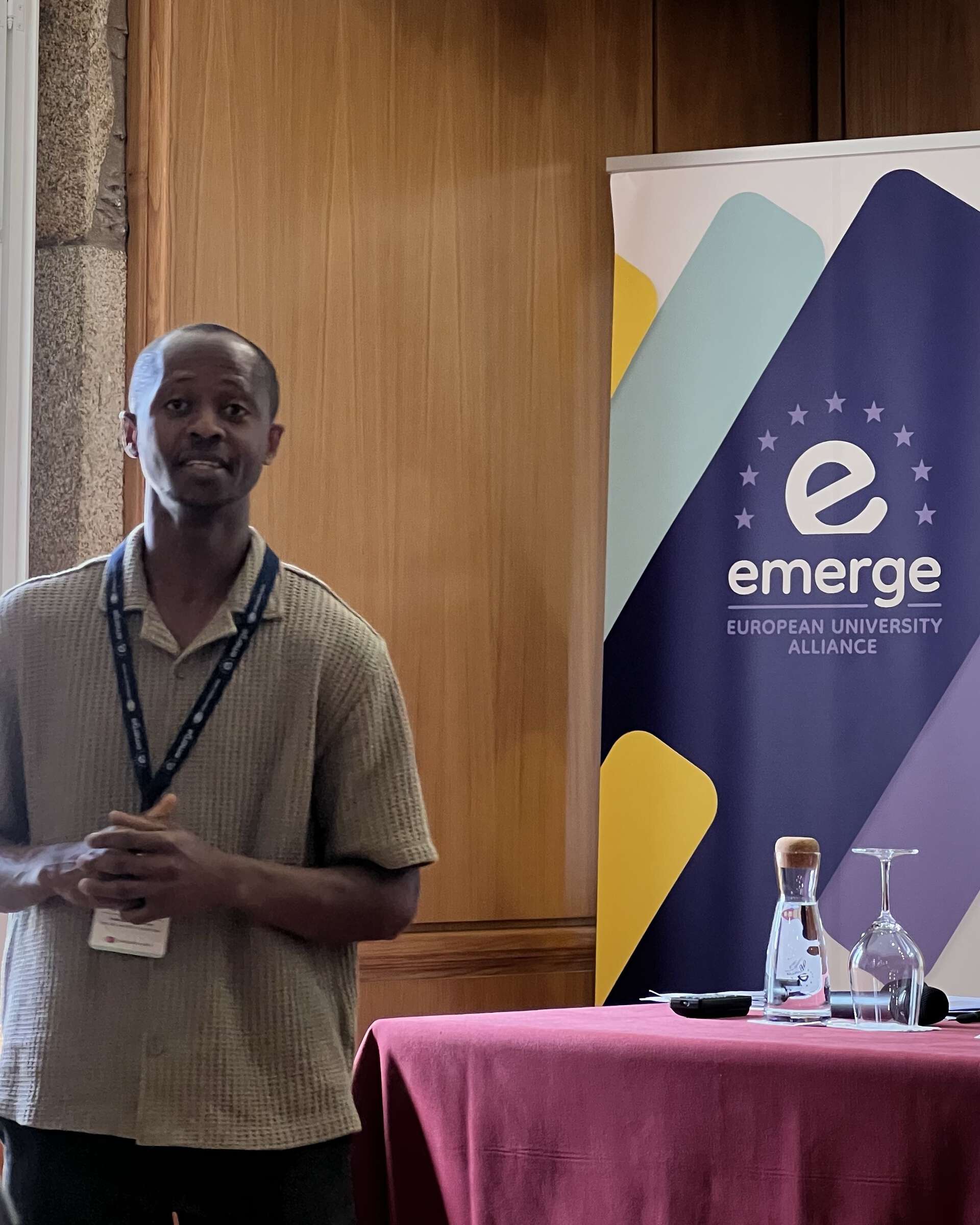 Abdul in front of EMERGE roll-up
