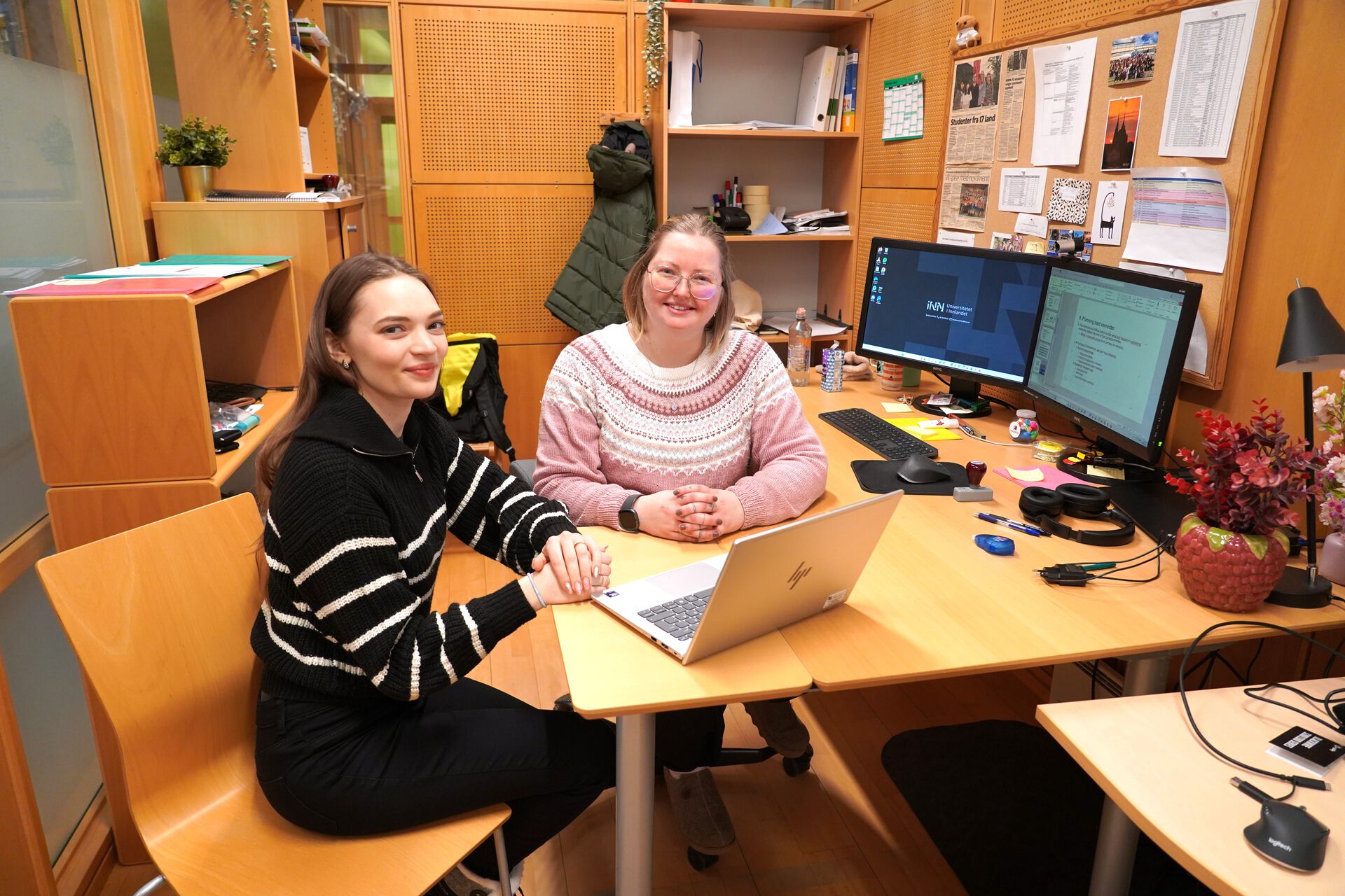 Yuliia and Kine are working together at the International Office. They are sitting together in front of a laptop