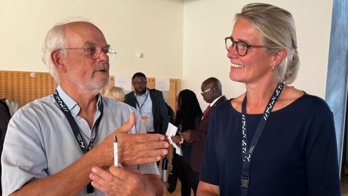 Two people are talking at a conference