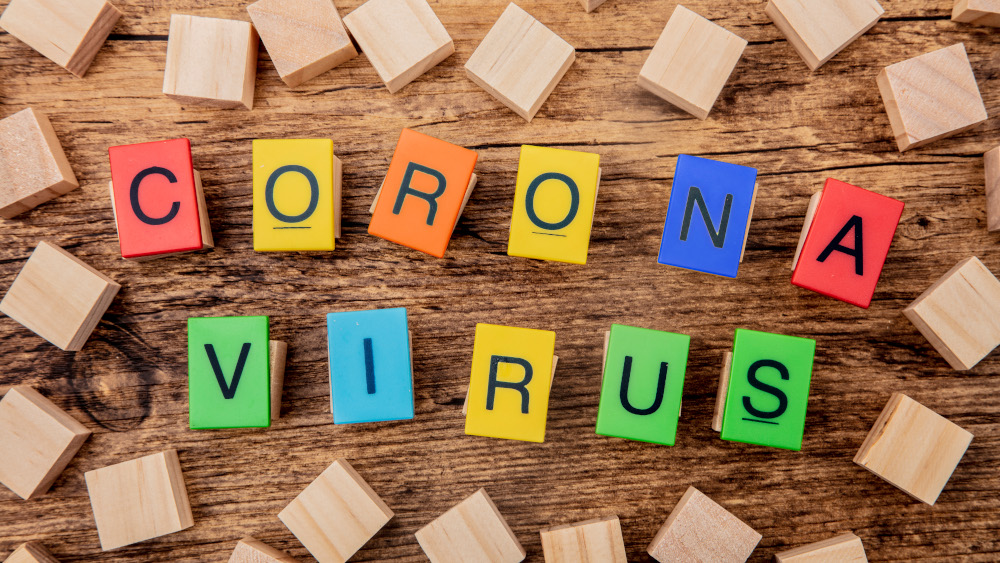 Colourful building blocks on a table showing the text corona virus