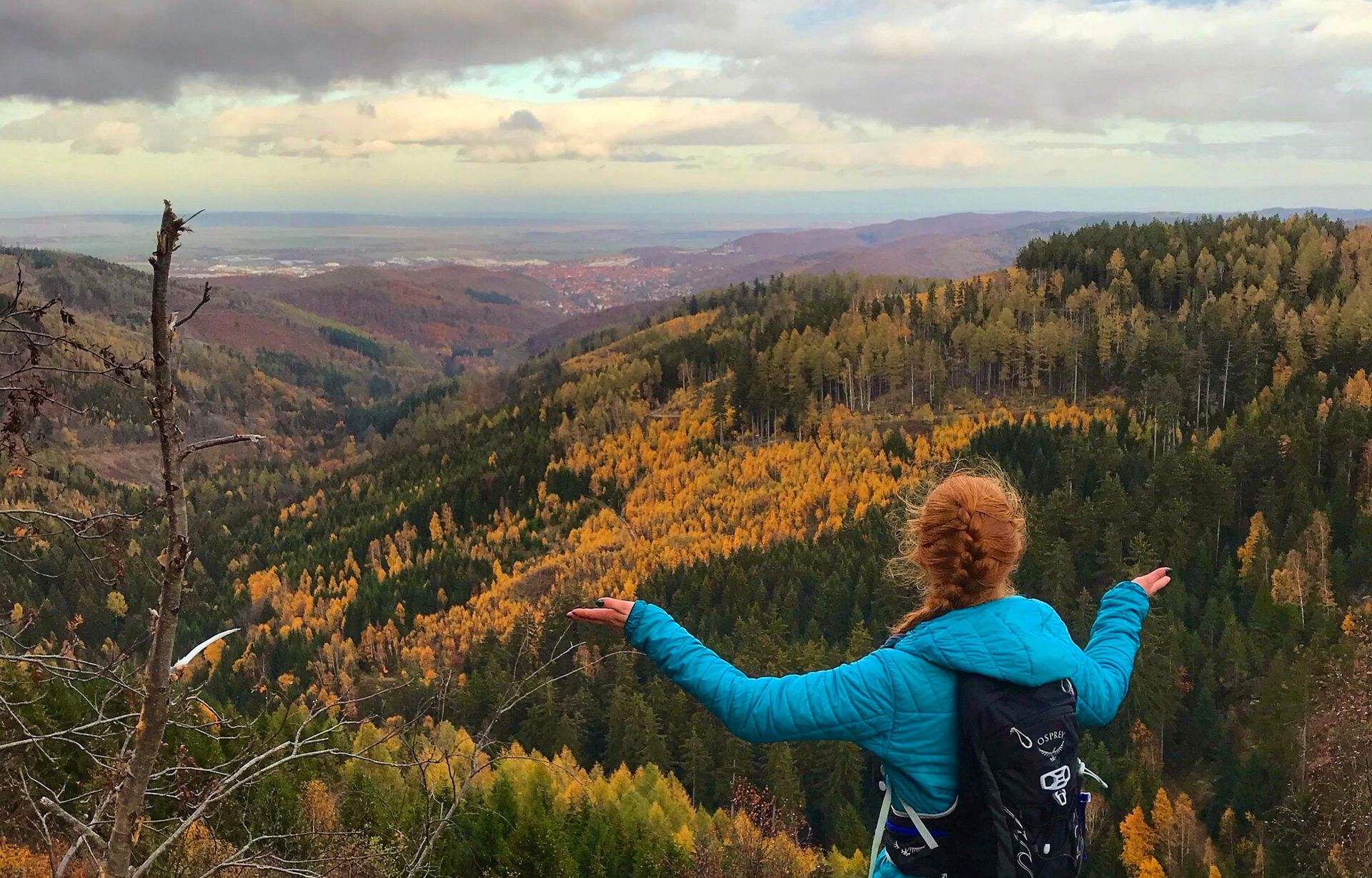 Exchange student looking at the view from atop a mountain hill