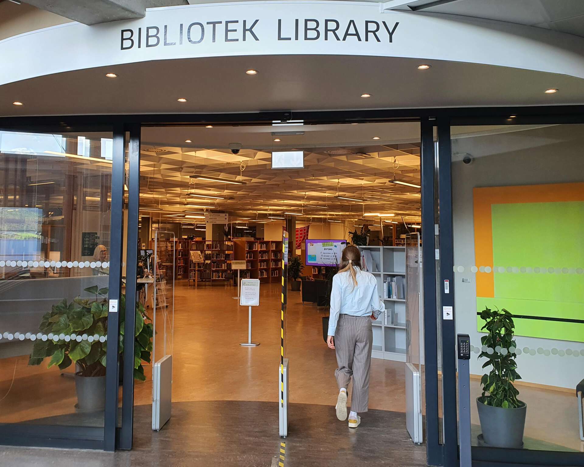 A woman entering a library