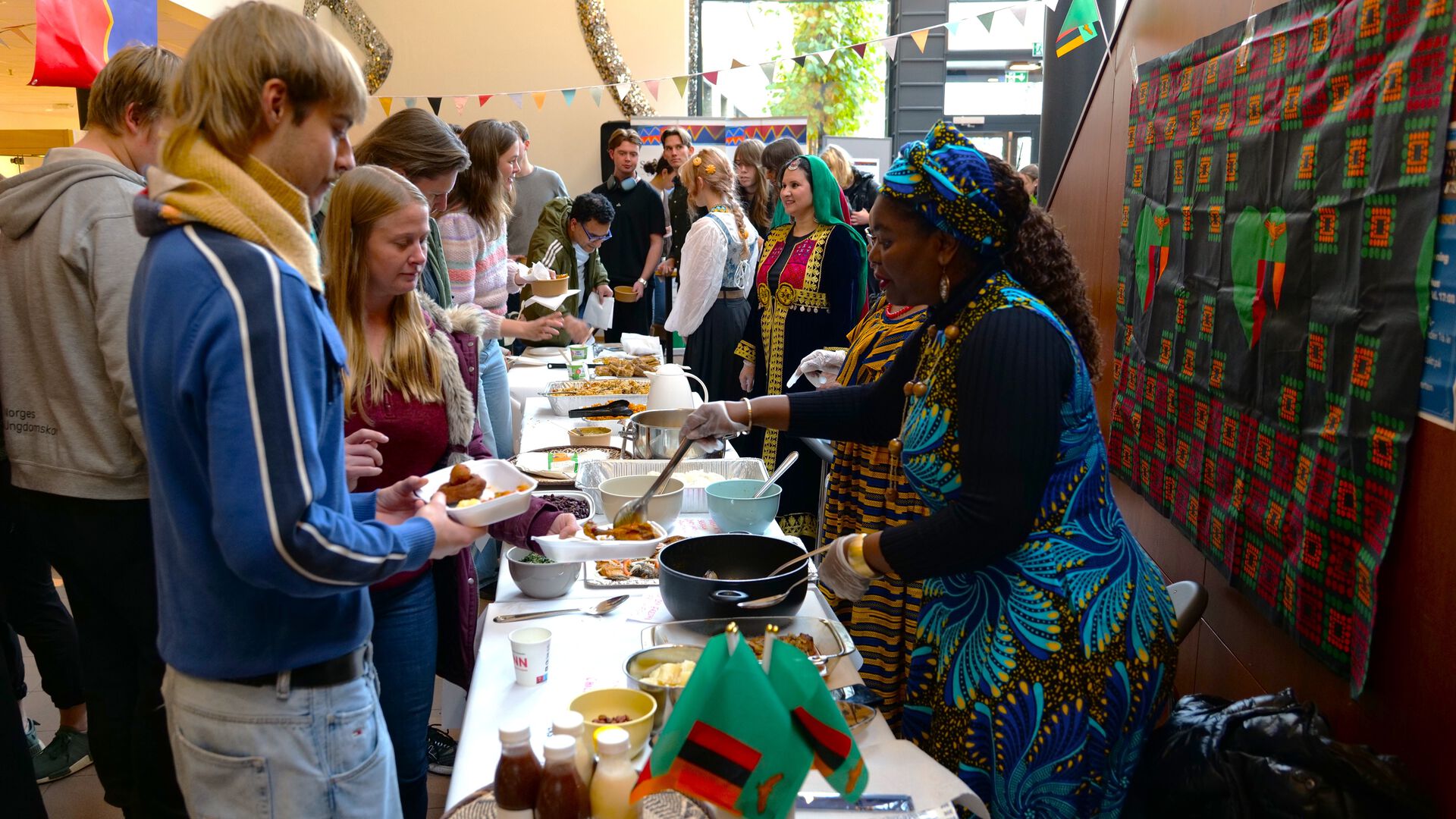 People surrounding tables of food
