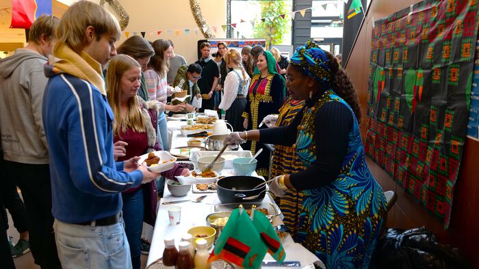 People surrounding tables of food