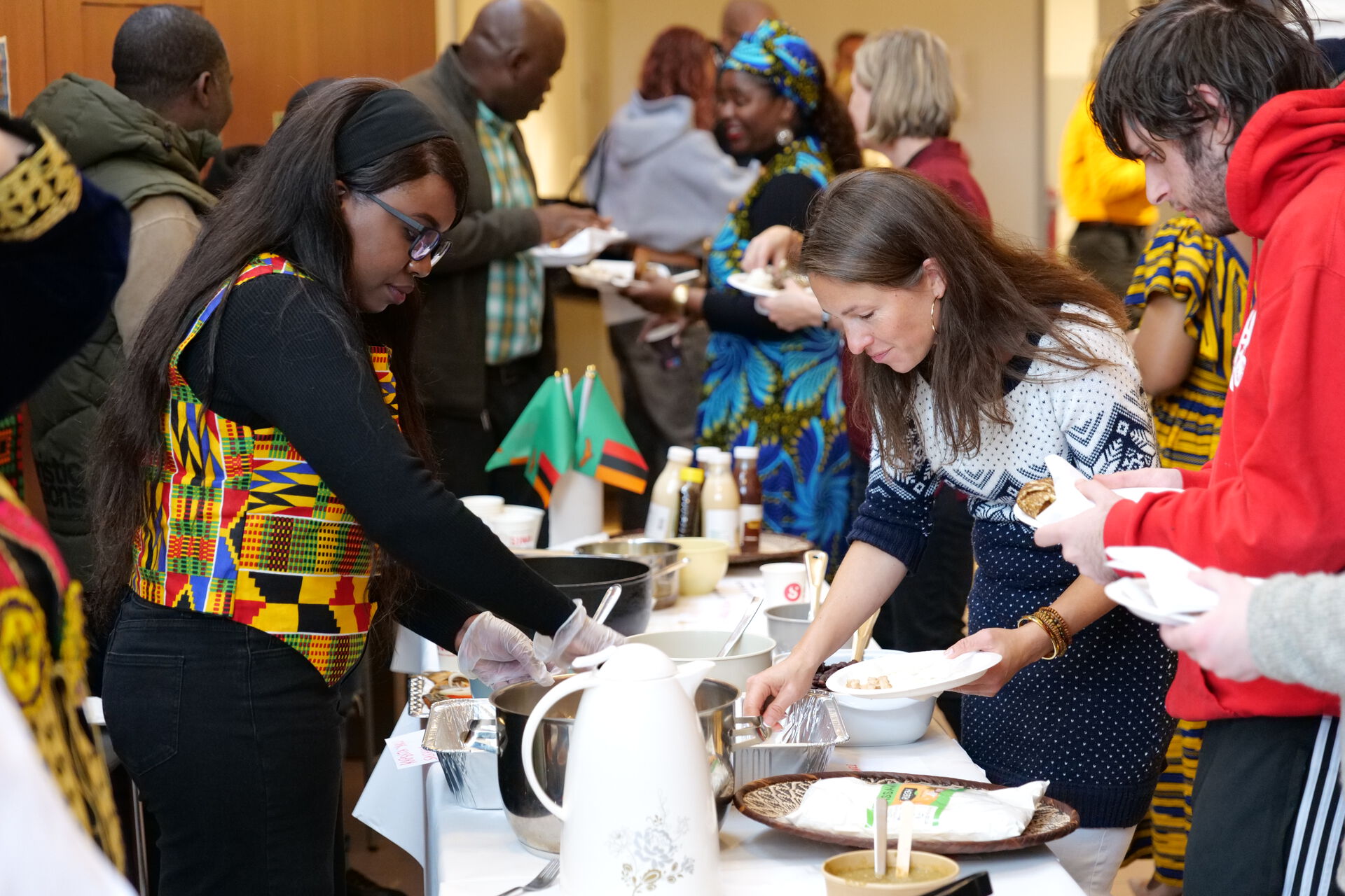 Different foods being served at a long table