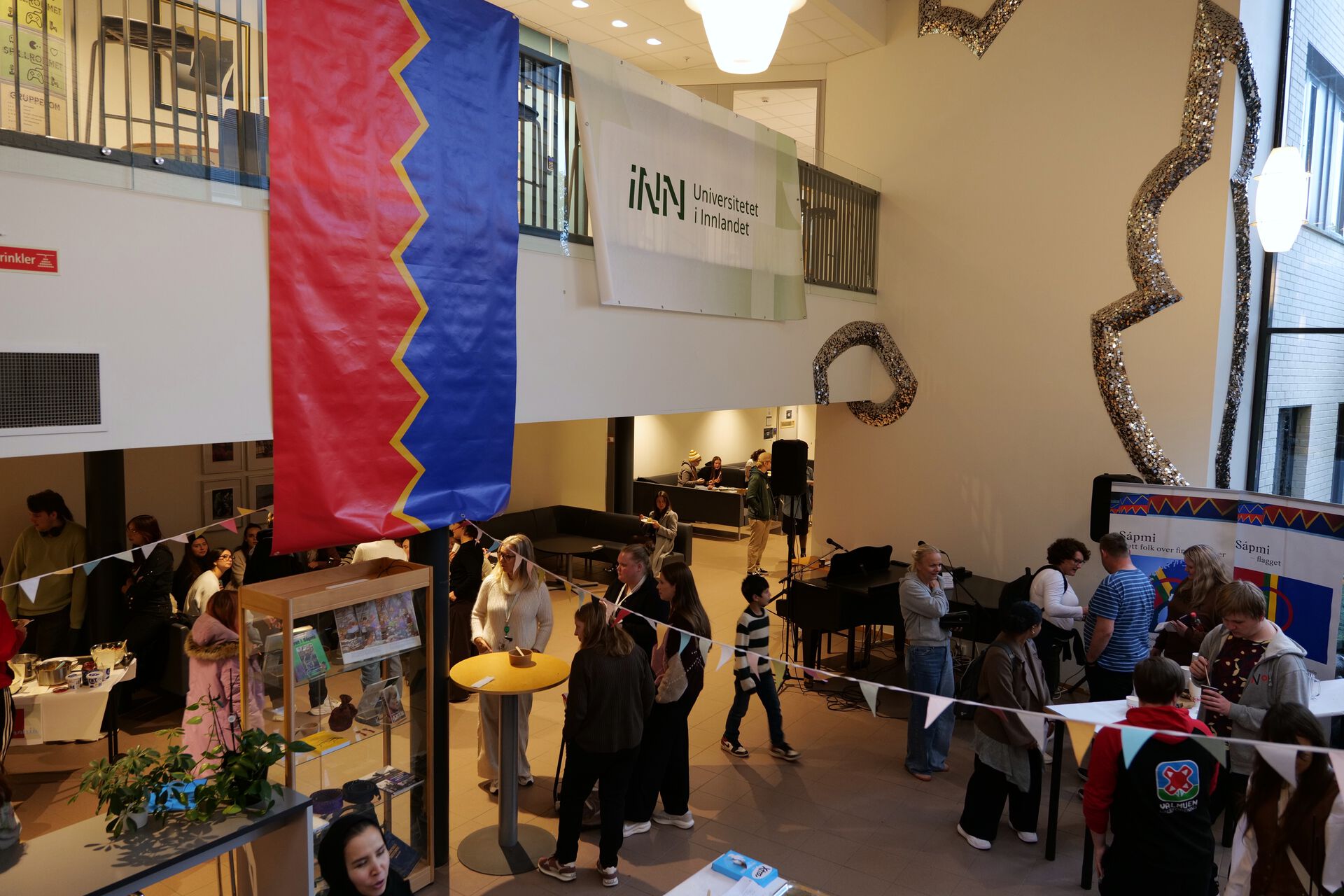 A sami poster next to an INN poster in the foyer