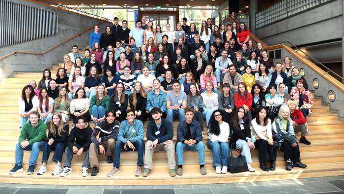 102 students sitting on stairs