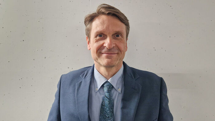 Man with blue jacket an a tie