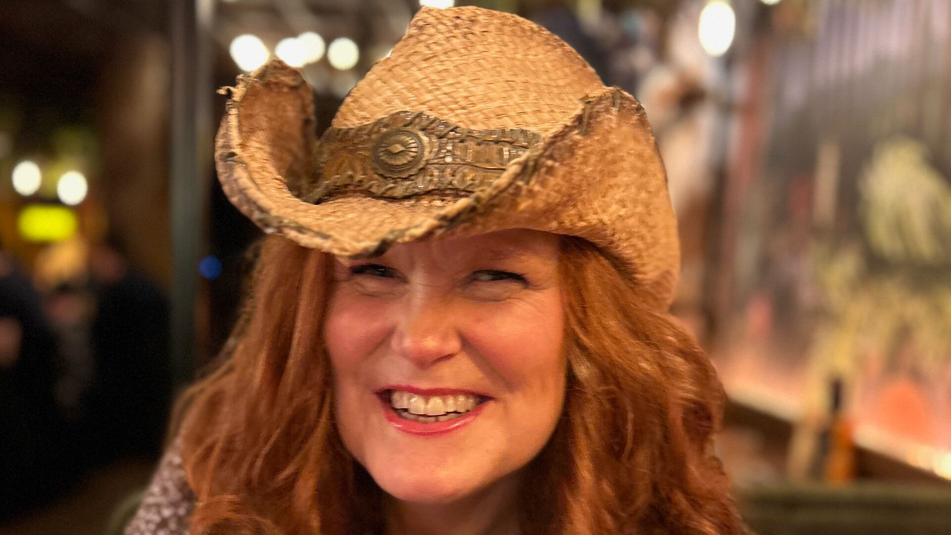 Lady with cowboyhat and red curly hair