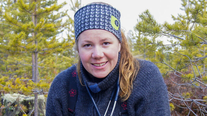 Portrait photo of Anne Randi in a forest. 