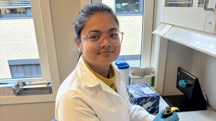 Young lady with white coat in a lab