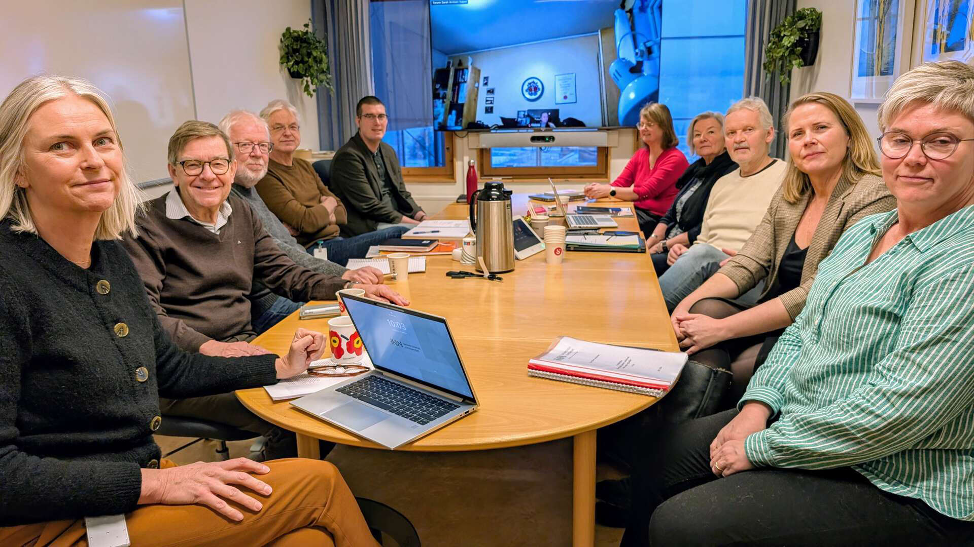 The research group together in a meeting room.