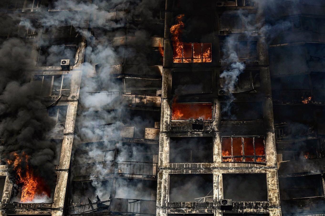 Burning building with lots of smoke and flames.