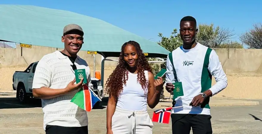 three students smiling