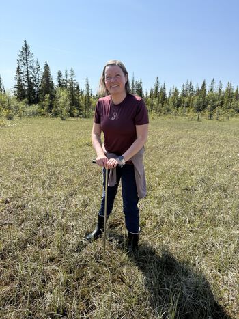 Lise W. D. Urset measures marsh depth with a peat probe at “Haremyra,” south of Stenfjellia in Hamar Municipality.