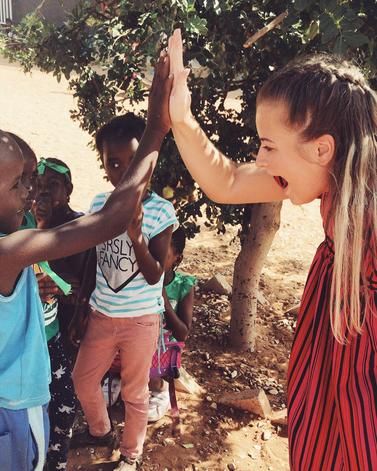 Student gives a high five to a child