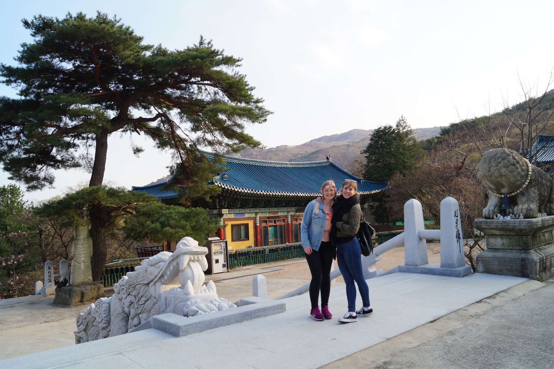 Two female students posing by a temple in South-Korea.
