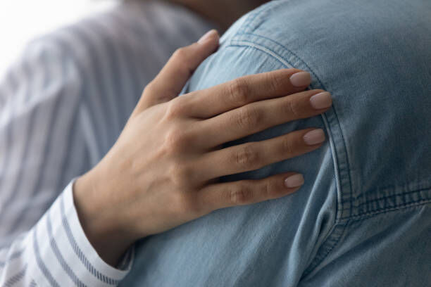 Caring hand on shoulder