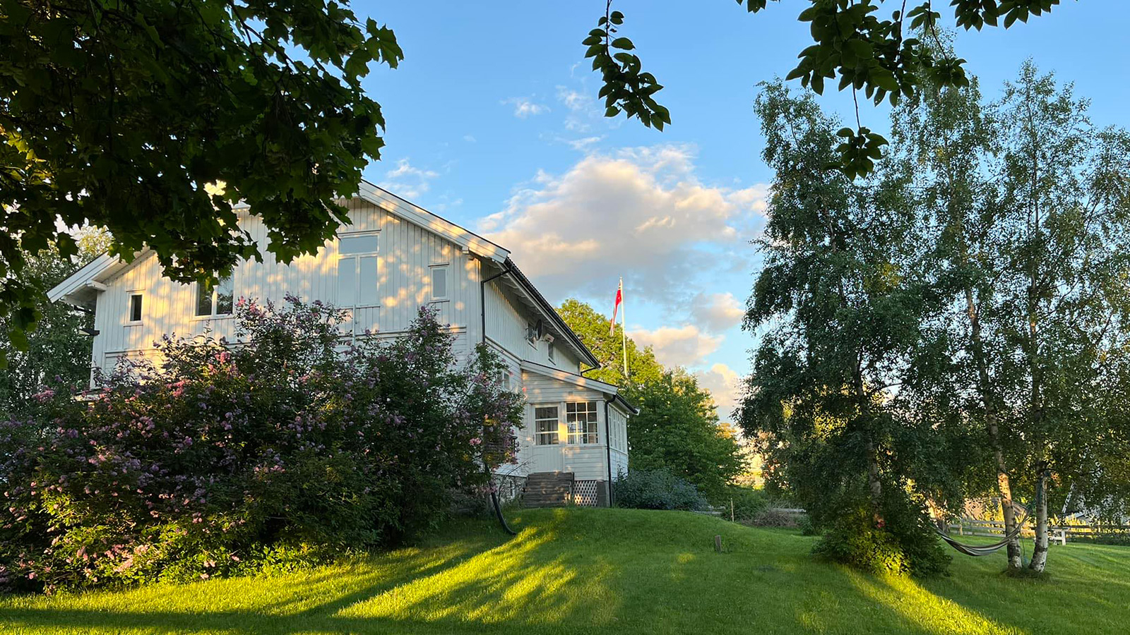 Bilde av prestegården sett fra hagen.
