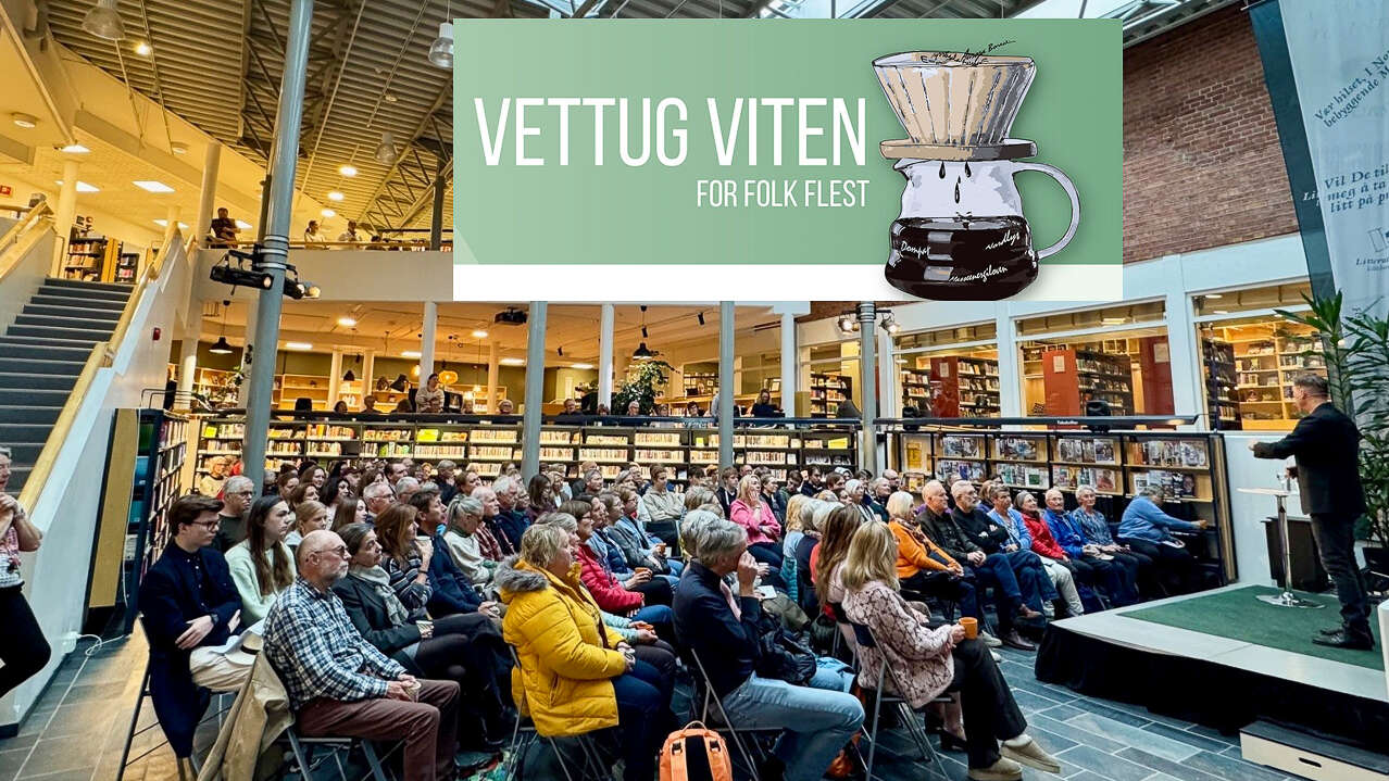 Et publikum på foredrag på et bibliotek