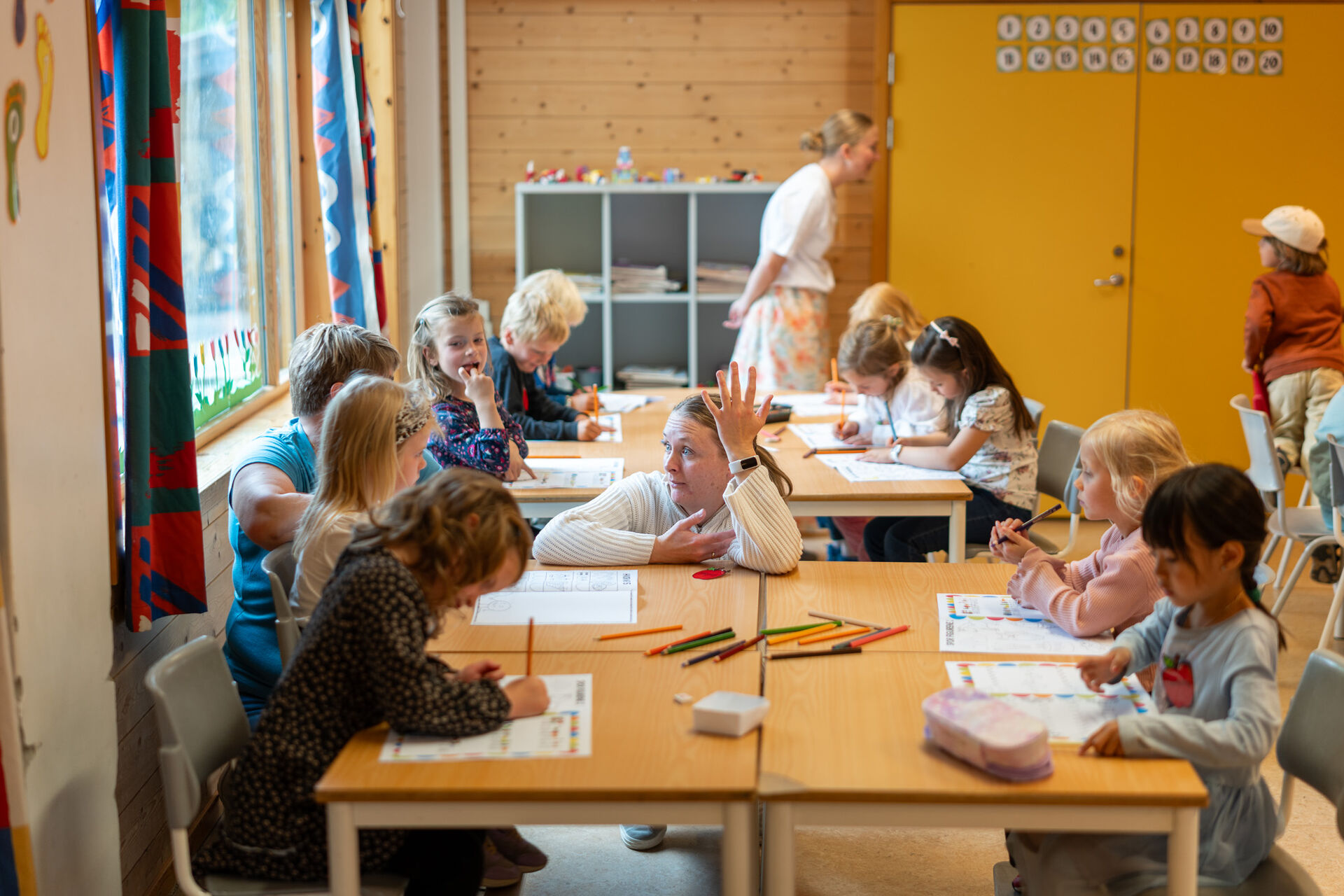 Skolestarterne sitter ved pulter i klasserommet.