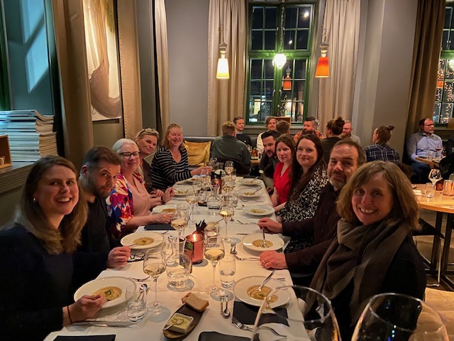 Forskergruppens medlemmer og gjester sitter til bords ved Hvelvet restaurant. Det dempet belysning og hyggelig atmosfære. 