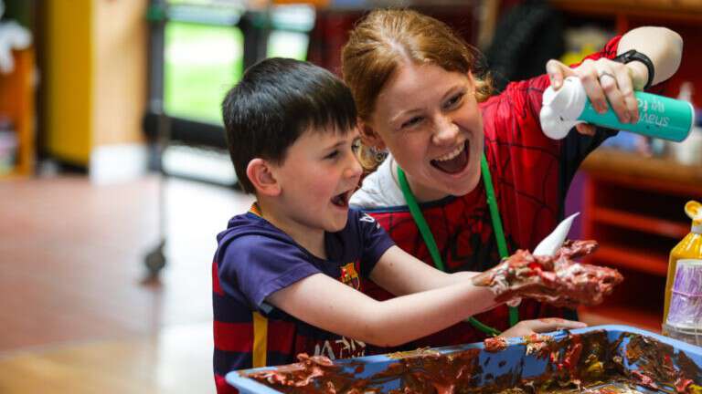An adult helping a child