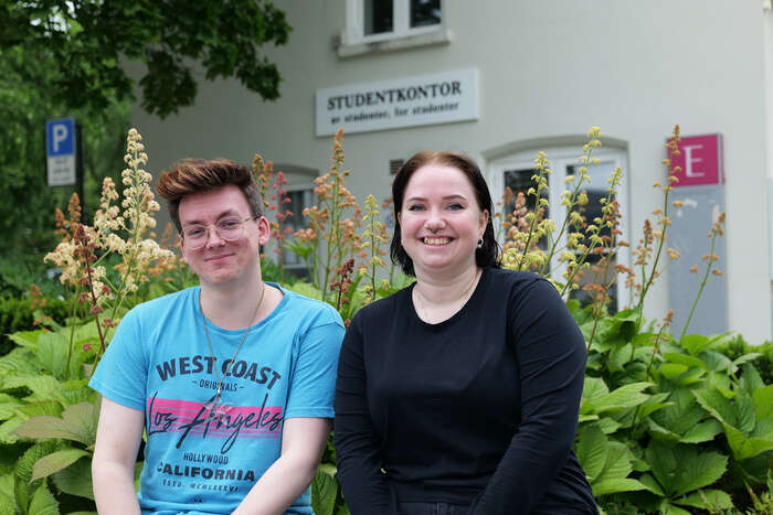 Bilde av fadderlederne sittende på en benk foran studentkontoret på studiested Hamar.