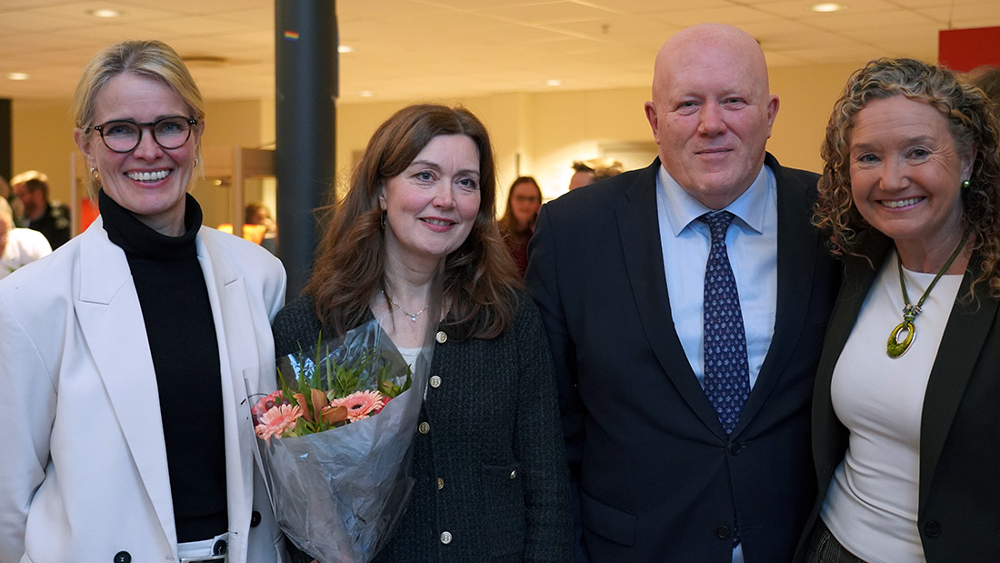 De fire prorektorene står samlet og smiler til kamera, de har fått en blomsterbukett
