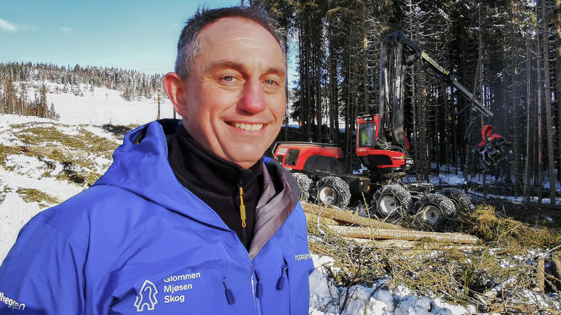Gudmund Nordtun i blå jakke ute i skogen på vinteren med snø