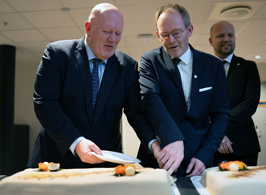 To menn som skjærer kake. 