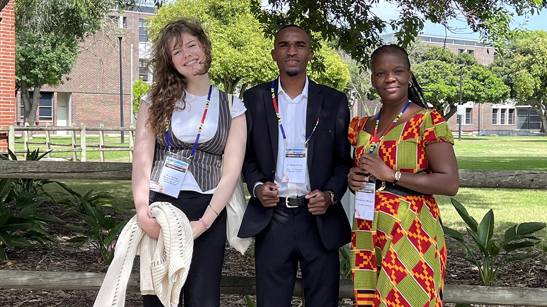 one norwegian and two namibian students at a conference. They are sitting outside in the sun
